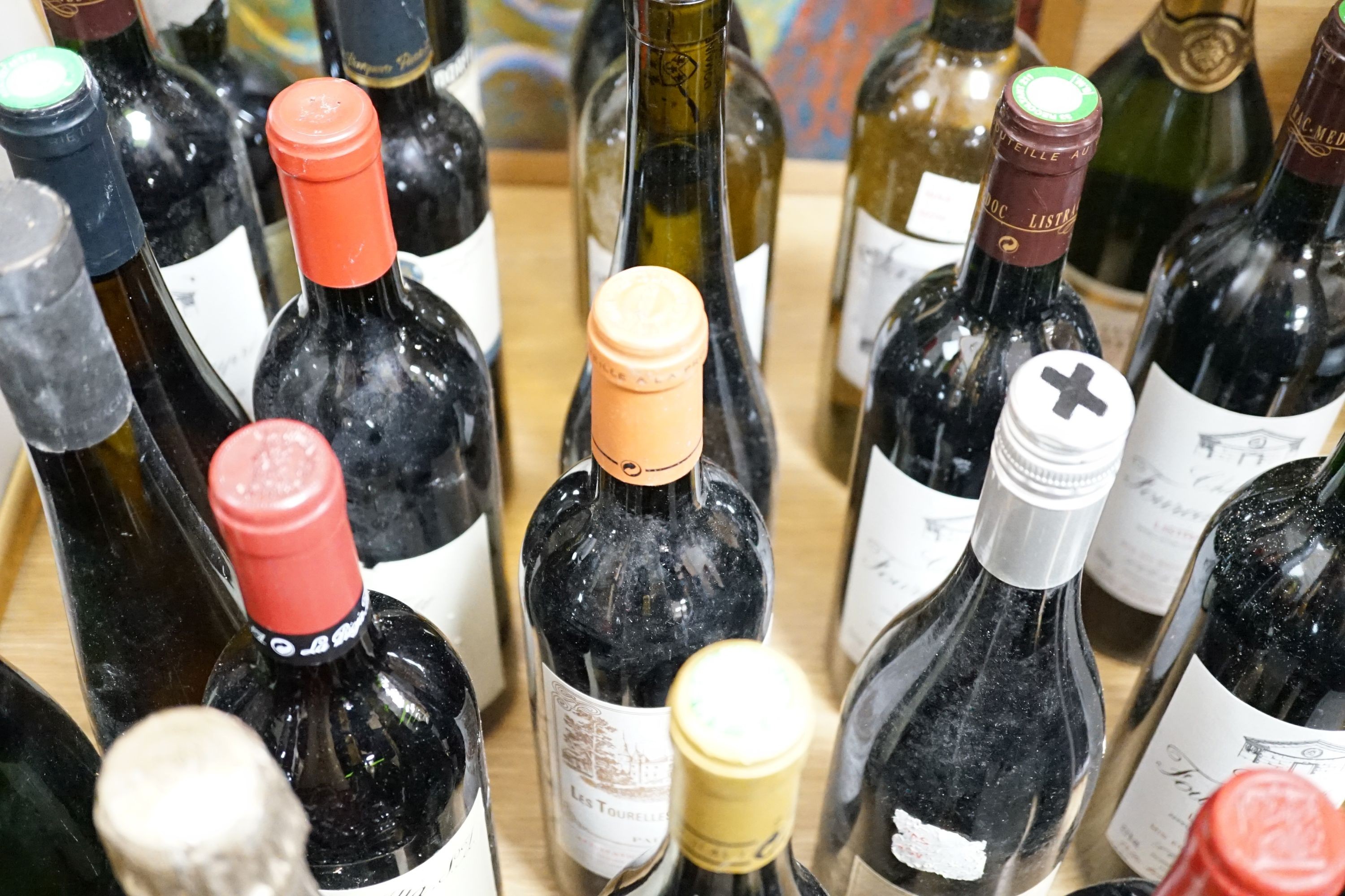 Twenty nine assorted bottles of wine is etc. including Les Tourelles de Longueville, 2003, Chateau Fourcas Dupre, 2000, Perrier Jouet Grand Brut Champagne, Chateau Sigognac, 1985 and Cote Rotie, 2001.